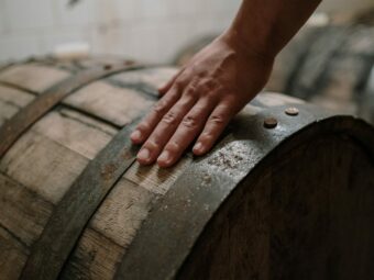 hand on the bourbon barrel